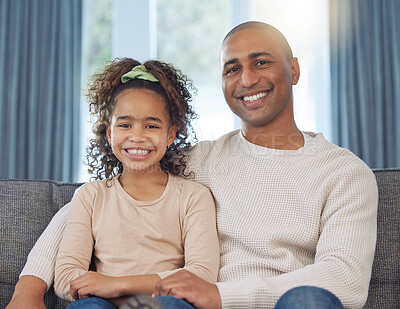 Buy stock photo Shot of an adorable little girl relaxing with her father on the sofa at home