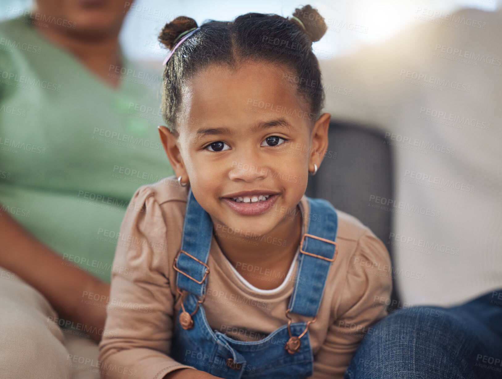 Buy stock photo Shot of an adorable little girl relaxing with her parents on the sofa at home