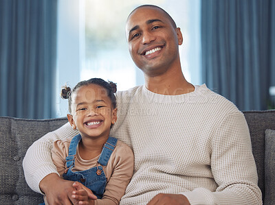 Buy stock photo Shot of an adorable little girl relaxing with her father on the sofa at home