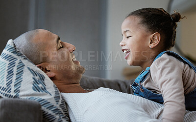 Buy stock photo Shot of a father and daughter bonding while playing on the sofa at home