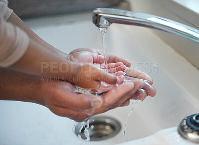 Buy stock photo Shot of an unrecognisable man helping his child wash their hands in the sink at home