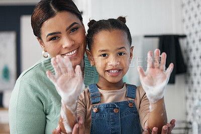 Buy stock photo Shot of a young woman helping her daughter wash her hands at home