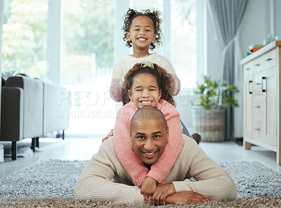 Buy stock photo Shot of a man bonding with his two daughters at home