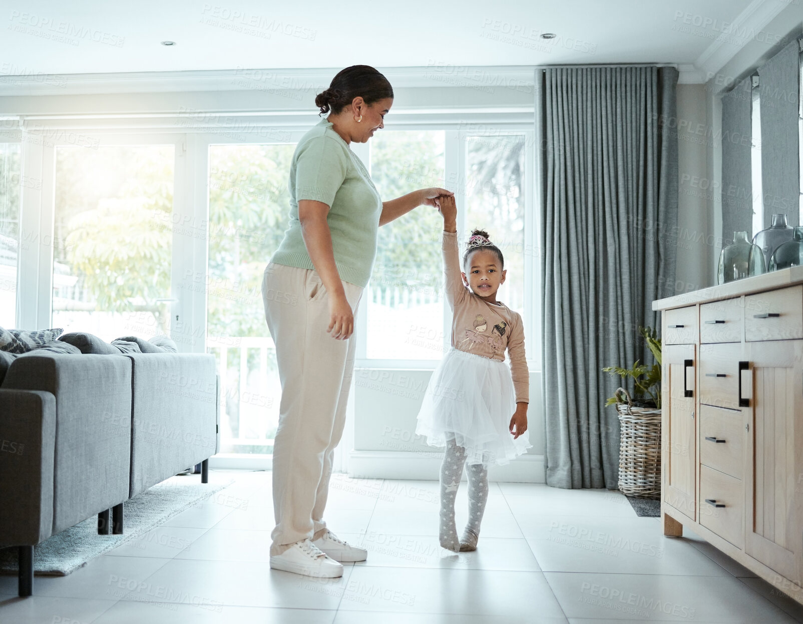 Buy stock photo Mother, girl and teaching dance to ballerina in home, support and help child for skill development. Mama, daughter and learning ballet in tutu for practice, childhood and kid for bonding in lounge