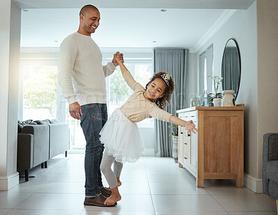Buy stock photo Shot of a little girl wearing her tutu and tiara while dancing with her father at home