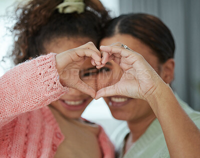 Buy stock photo Cropped shot of a little girl and her mother forming a heart shape with their hands