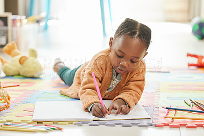 Buy stock photo Black girl, floor and learning with art education, drawing and color to relax, happiness and writing. Female kid, toddler and young person on the ground, home and child development with happiness