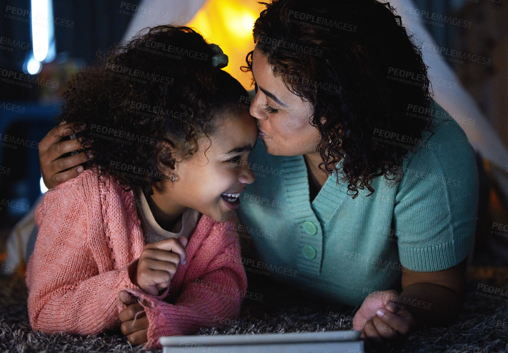 Buy stock photo Mom, tablet and kiss happy kid in home for care, love or connection together on floor. Mother, girl and child on technology for bonding, game or family watch cartoon with parent at night to relax