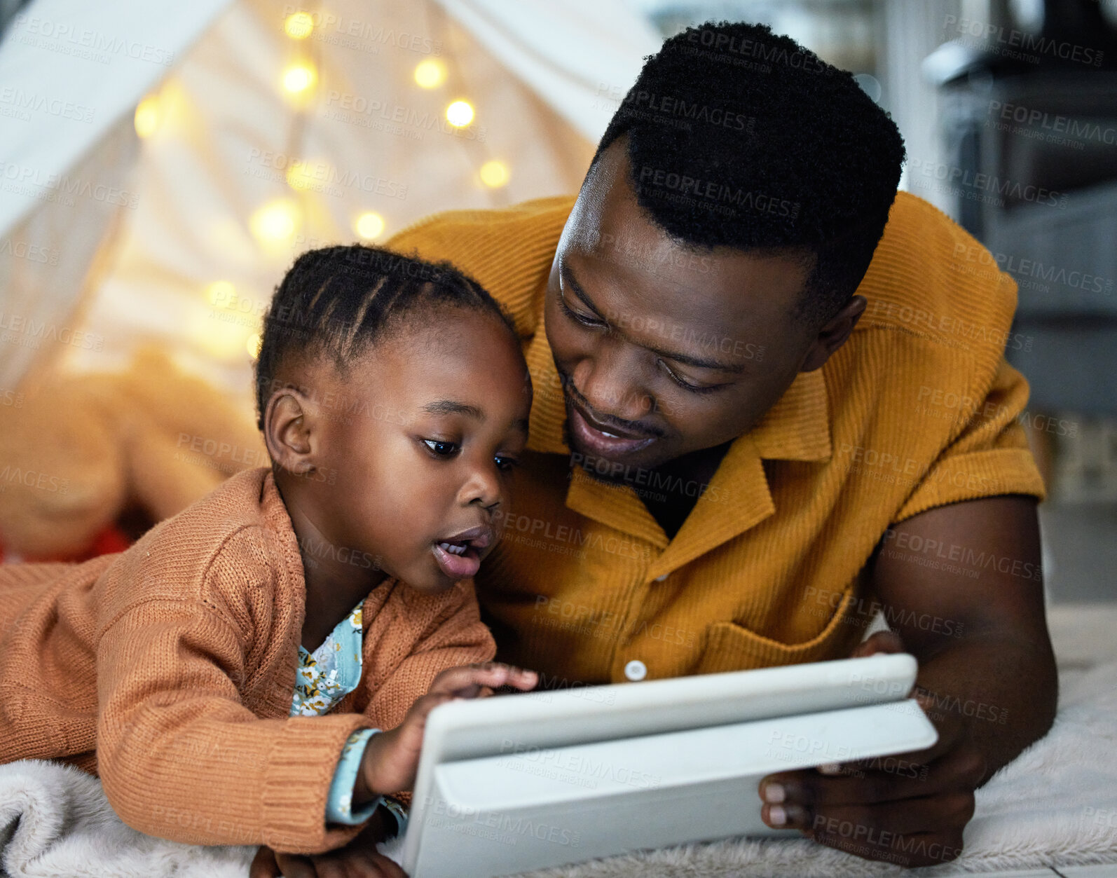 Buy stock photo Black man, smile and girl relax with tablet at night for streaming story online, watch movie and bonding in tent. African, father and child with digital for storytelling , care and love at house