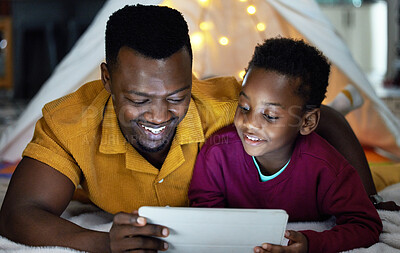 Buy stock photo Black man, smile and child relax with tablet at night for streaming story online, watch movie and bonding in tent. African, father and boy with digital for storytelling, care and love at house
