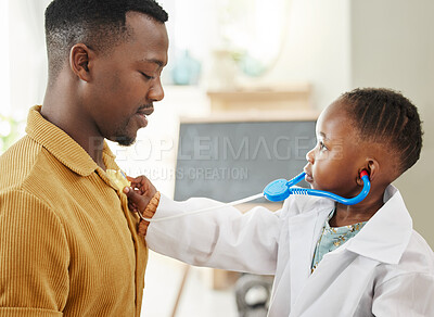 Buy stock photo Shot of a little girl pretending to be a doctor while playing with her father