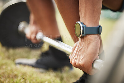 Buy stock photo Cropped shot of an unrecognizable male athlete lifting weights while exercising outdoors