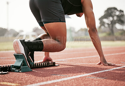 Buy stock photo Rearview shot of an unrecognizable young male athlete starting his race on a track