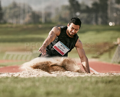 Buy stock photo Full length shot of a handsome young man competing in a long jump event outside