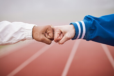 Buy stock photo Cropped shot of two unrecognizable female athletes fist bumping outside