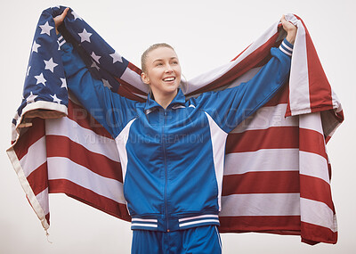 Buy stock photo Cropped shot of an attractive young female athlete celebrating a victory for her country