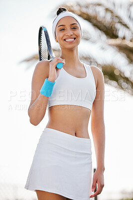 Buy stock photo Shot of an attractive young tennis player standing alone on the court during practice