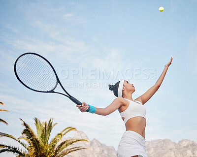 Buy stock photo Shot of young tennis player standing alone on the court and serving the ball during practice