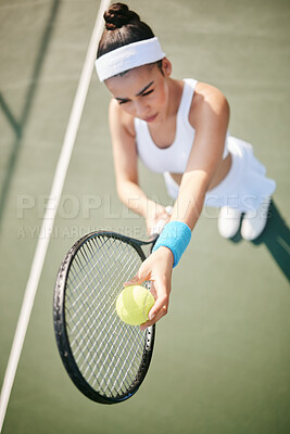 Buy stock photo High angle shot of a young tennis player standing on the court and getting ready to serve during practice