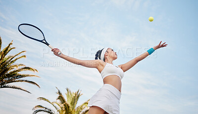 Buy stock photo Low angle shot of young tennis player standing alone on the court and serving the ball during practice
