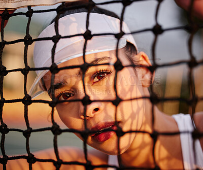 Buy stock photo Shot of a tennis player sitting behind the net