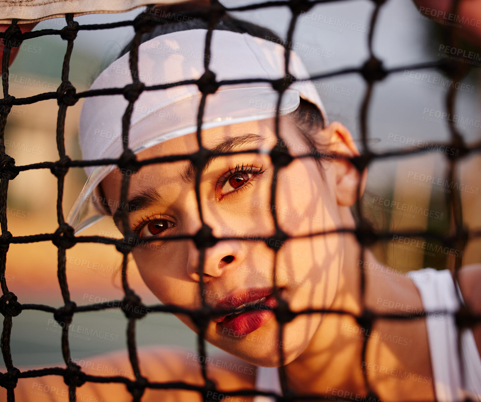 Buy stock photo Shot of a tennis player sitting behind the net