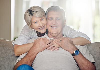 Buy stock photo Shot of a mature couple sitting on the couch at home
