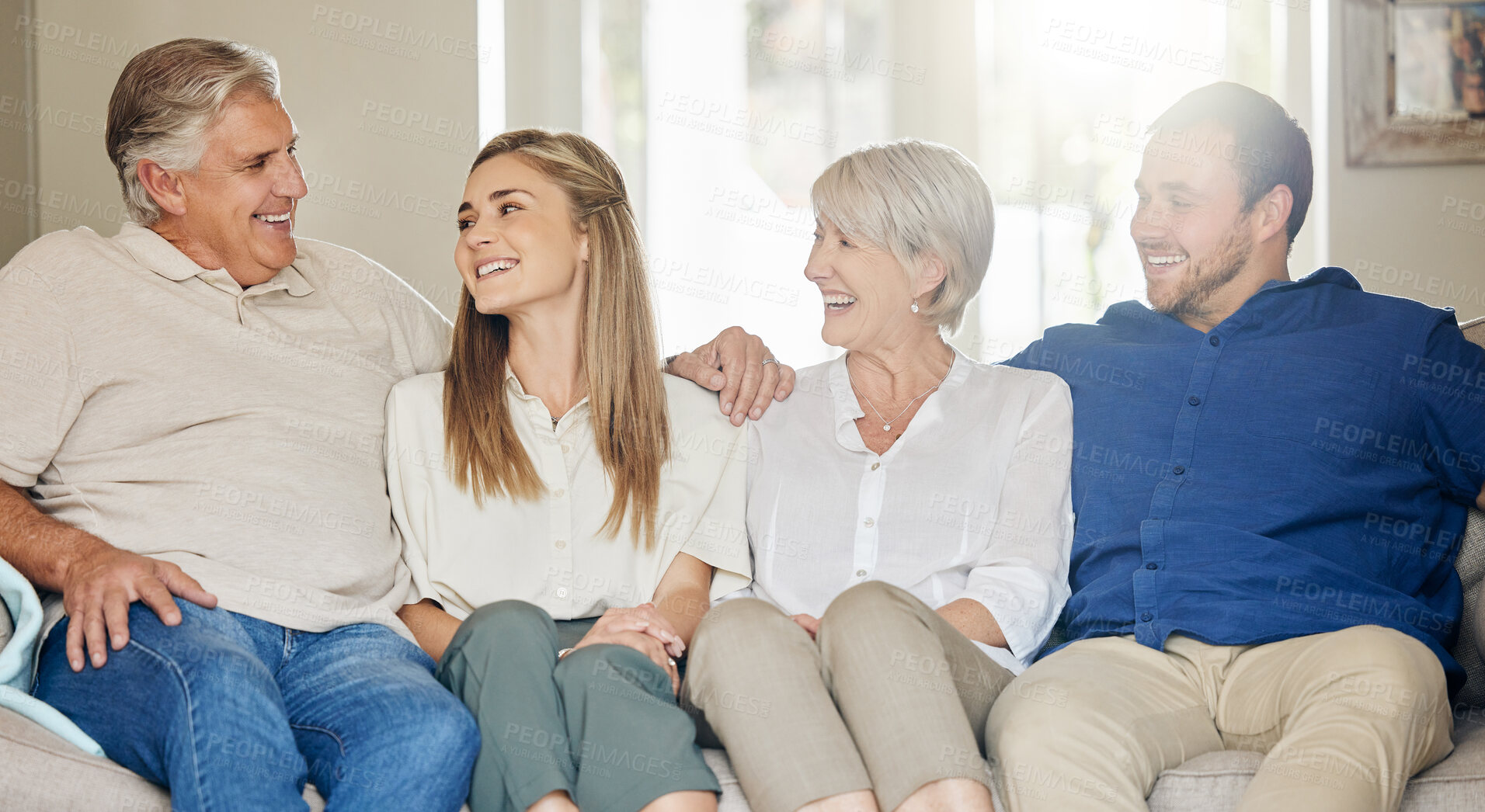 Buy stock photo Happy family, parents and adult kids on sofa in home with bonding, laughing and funny joke with love in living room. Women, men and affection on couch in lounge for weekend visit, excited and relax