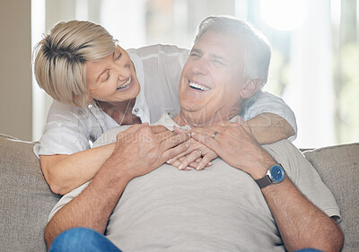 Buy stock photo Shot of a mature couple sitting on the couch at home