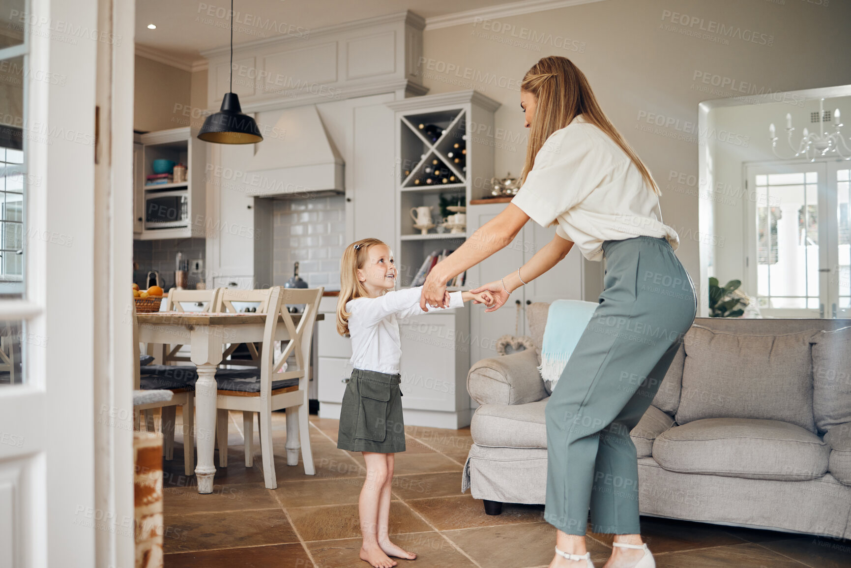 Buy stock photo Shot of a mother dancing with her daughter at home