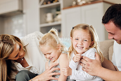 Buy stock photo Shot of a young family on the couch at home