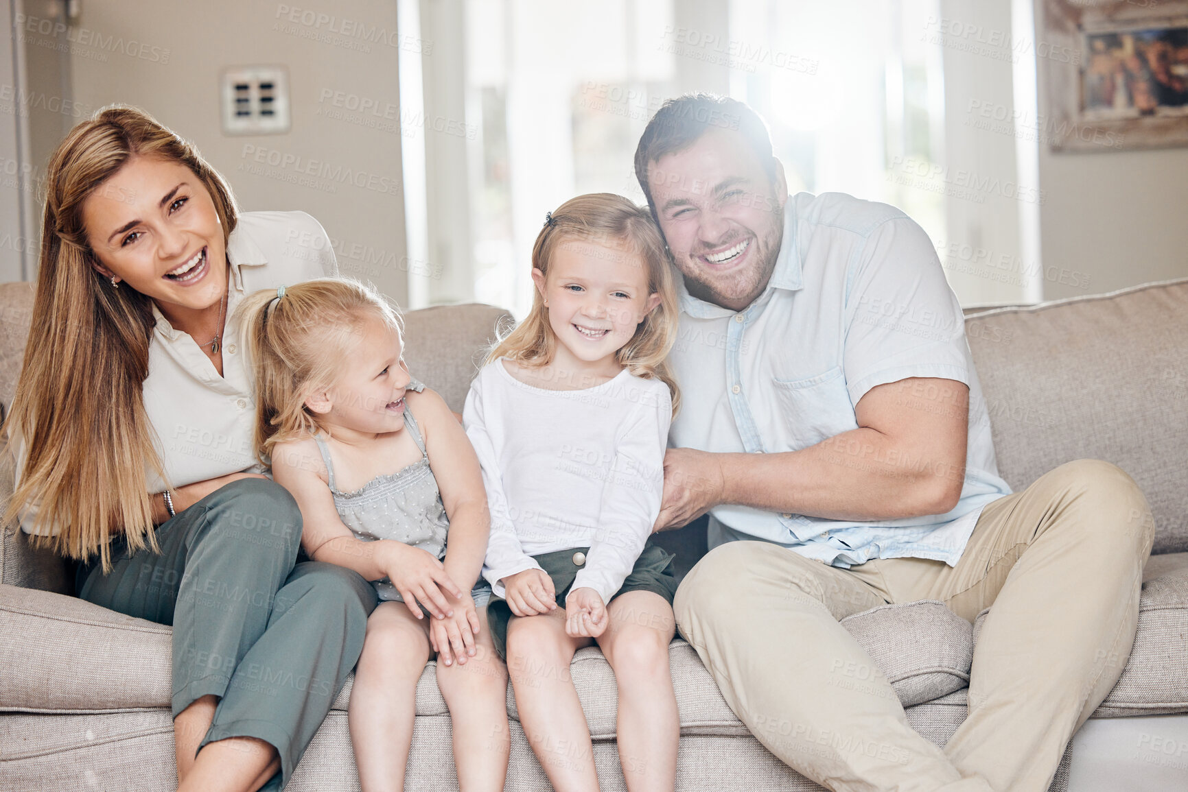 Buy stock photo Happy family, playing and parents with children on sofa in home for bonding, laughing or relax with love in living room. Smile, people or parenthood on couch in lounge on weekend, excited and caring