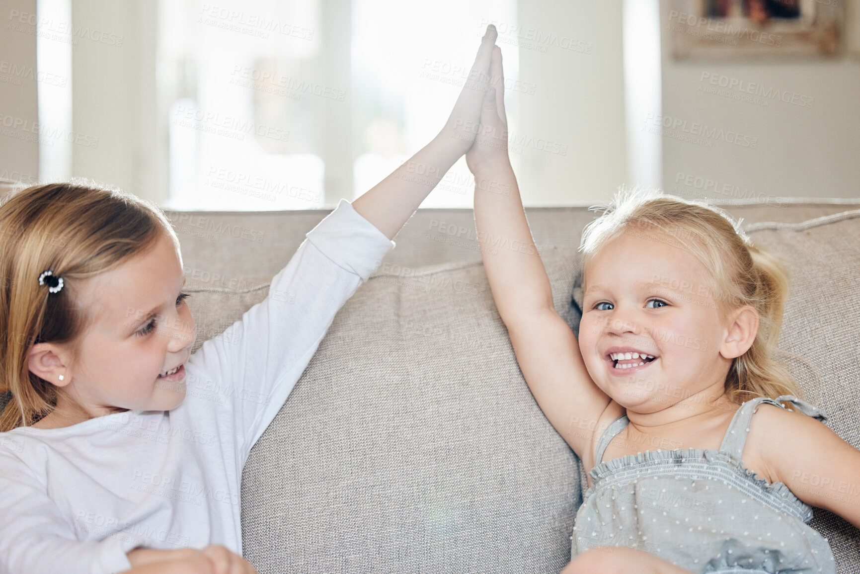 Buy stock photo Sofa, sibling and children with high five in portrait for connection, support and agreement. Girl, kids and happy with gesture in living room of home for sisterhood, bonding and achievement in growth