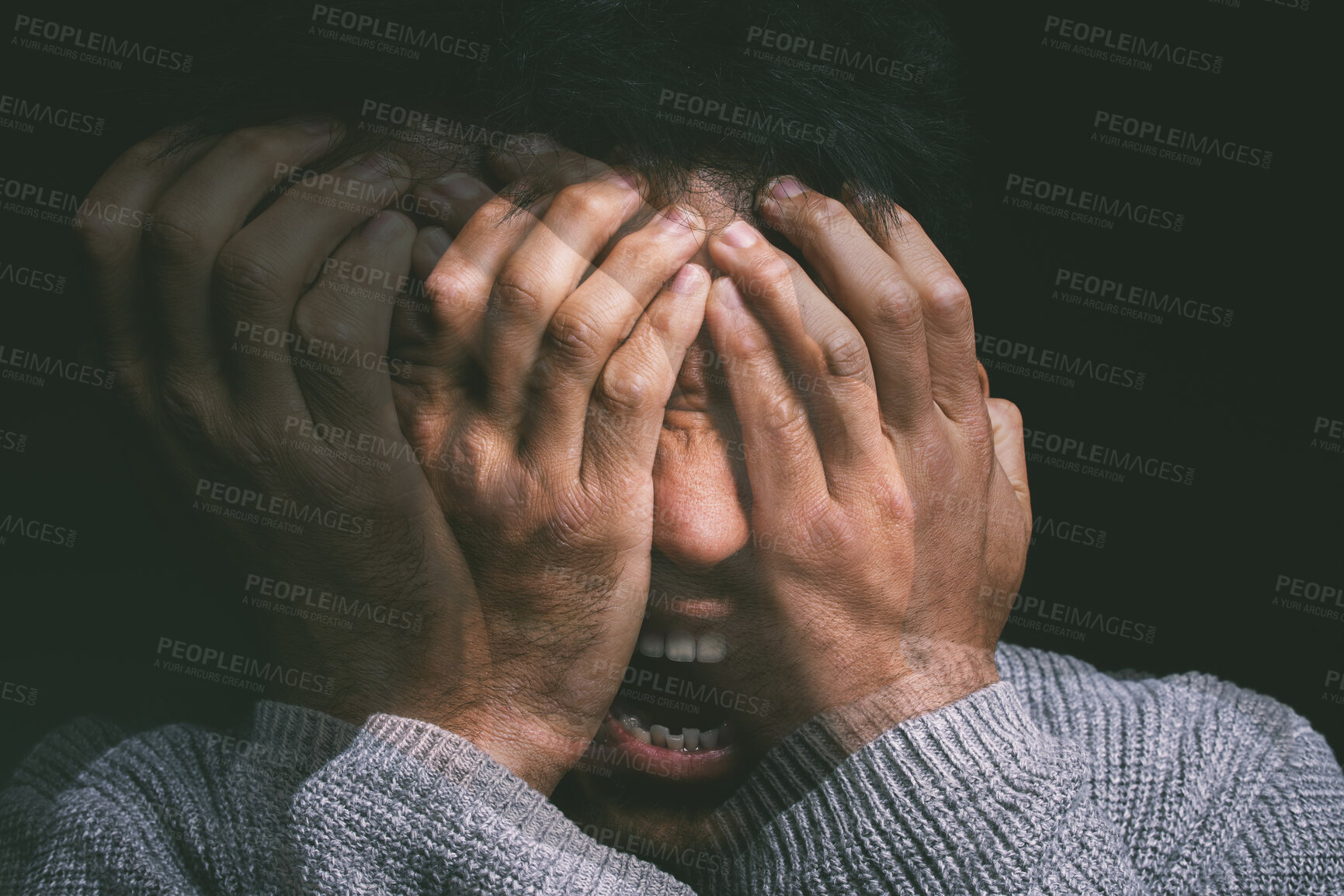 Buy stock photo Studio shot of a young man experiencing mental anguish and screaming against a black background