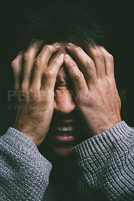 Buy stock photo Studio shot of a young man experiencing mental anguish and screaming against a black background