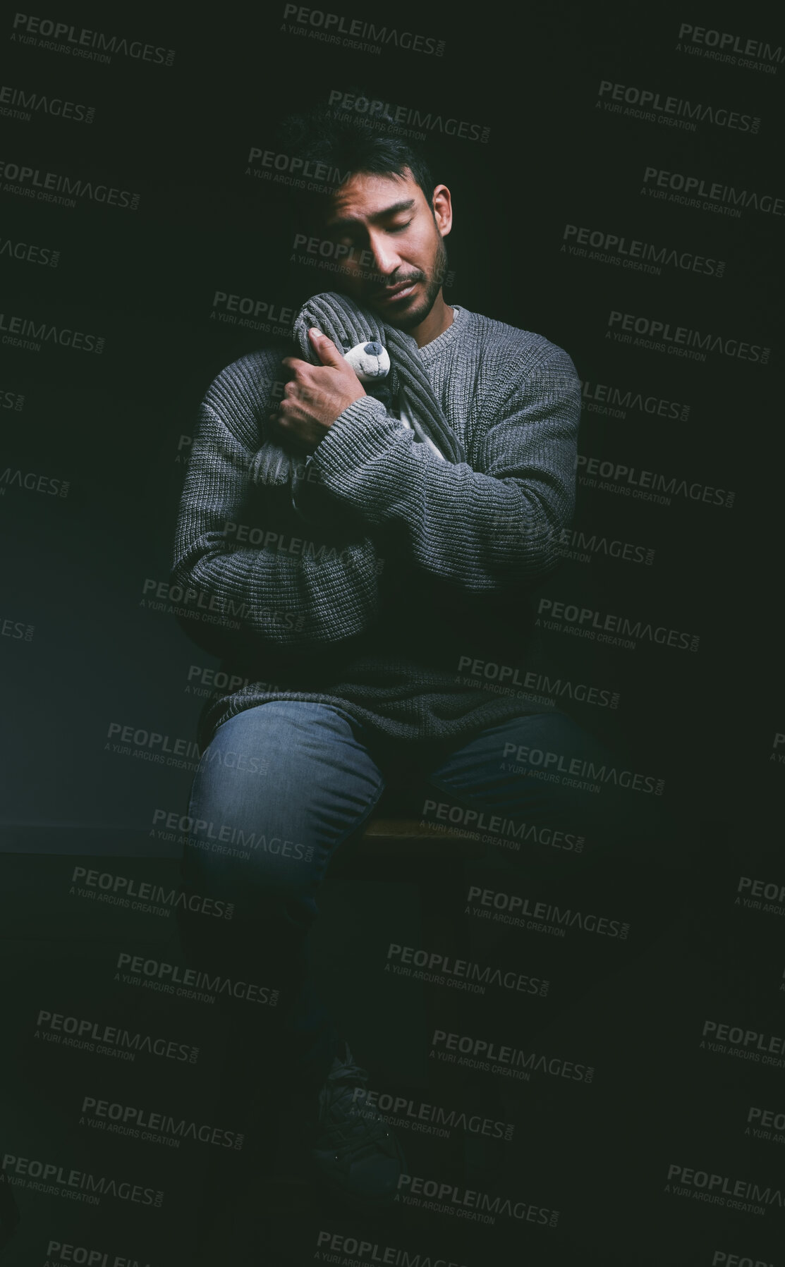 Buy stock photo Mental health, sad and man with teddy bear in studio for trauma support, help and emotional safety. Comfort, recovery and person with stuffed animal for ptsd, relief or healing on black background