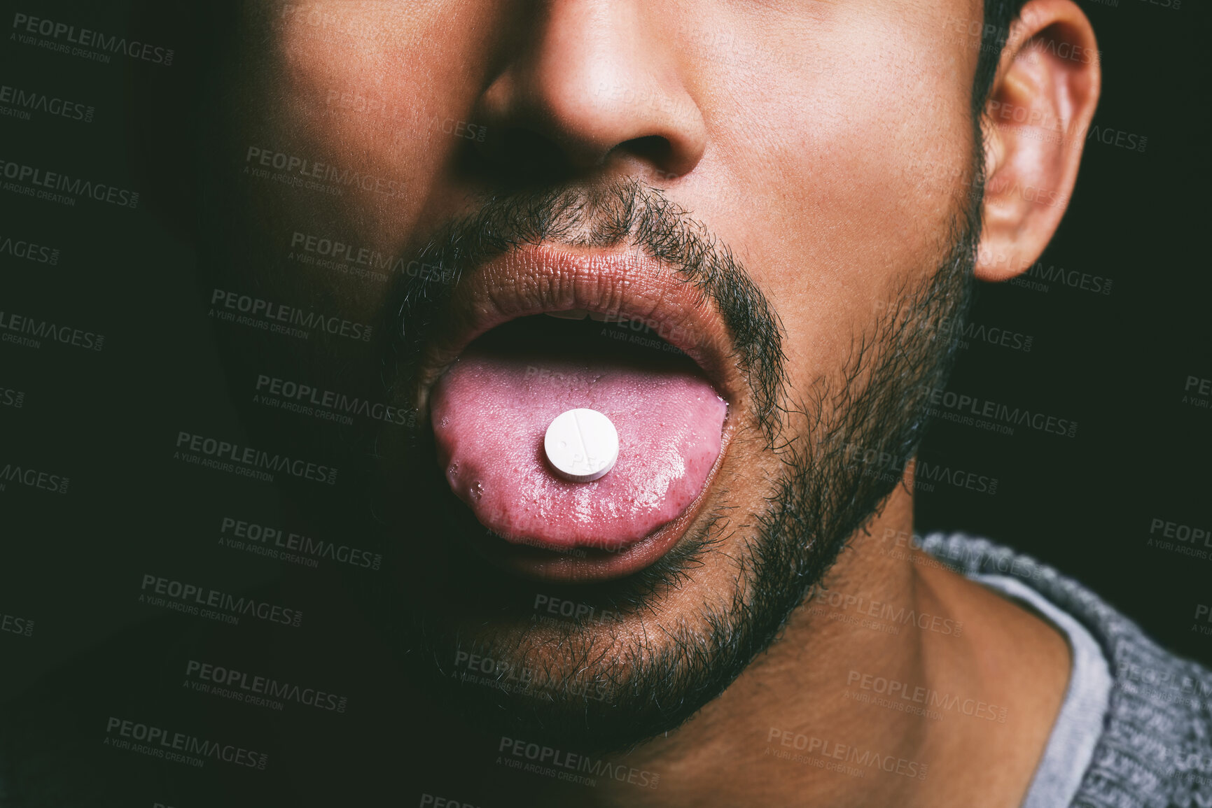 Buy stock photo Drug, mouth and man with pill, in studio for medication, relief or healthcare against on dark background. Tongue, addict and male person taking medical supplement, vitamin tablet or substance abuse