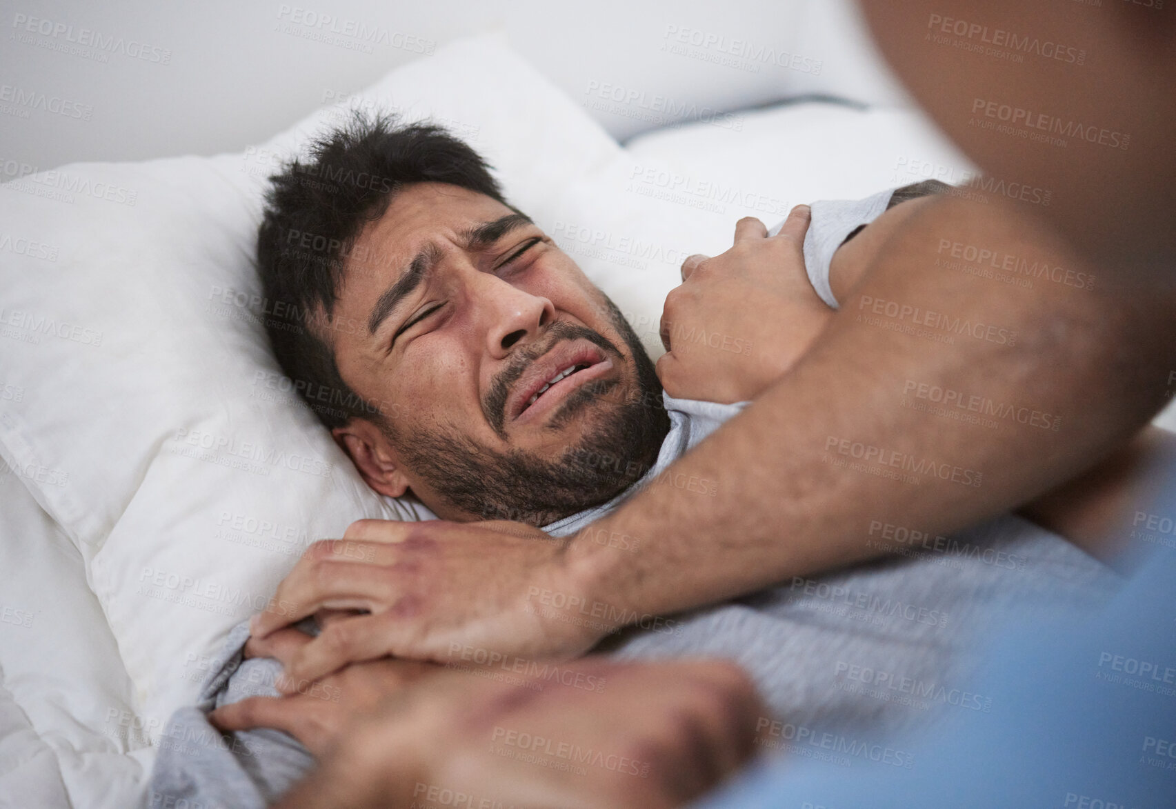 Buy stock photo Shot of a young man crying in a mental asylum