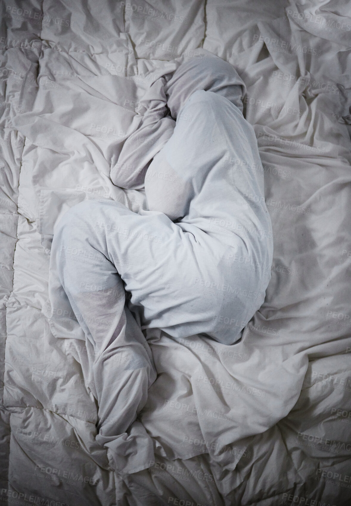 Buy stock photo Shot of a unrecognizable man laying under the covers in a mental asylum