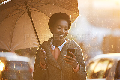 Buy stock photo Smile, umbrella and black woman with a smartphone, typing and connection for social media, network or sms. Female person outdoor, rain or girl with a cellphone, mobile app or chatting with insurance