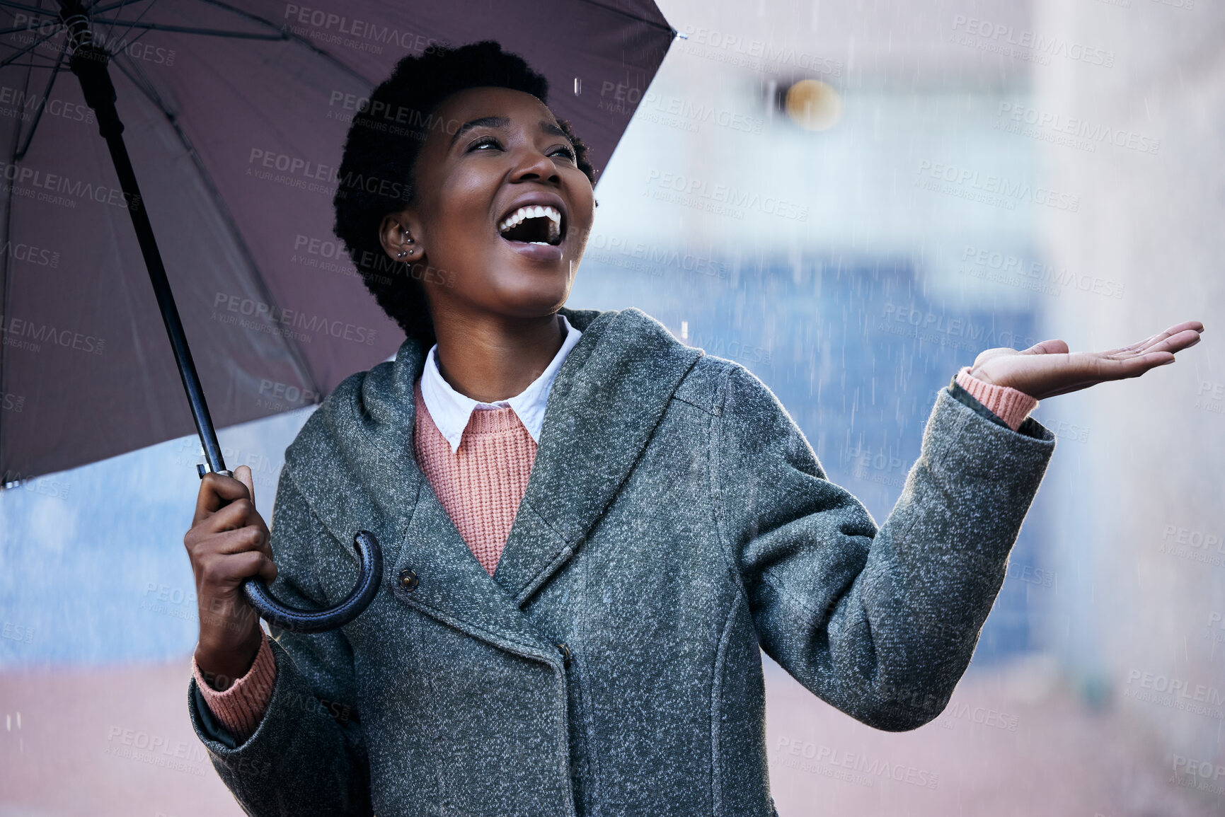 Buy stock photo Rain, smile and African businesswoman with umbrella for cover and happiness in city with travel for work. Water, weather and female person in street for insurance, career and walking in winter