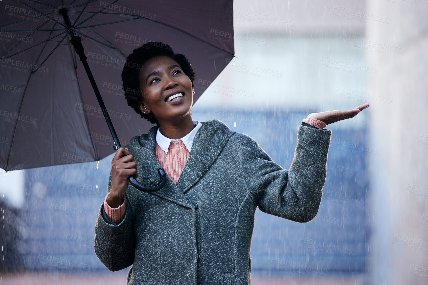 Buy stock photo Rain, smile and African businesswoman with umbrella for cover and happy for travel and work in city. Water, weather and commute in street for insurance with protection while walking in New York 