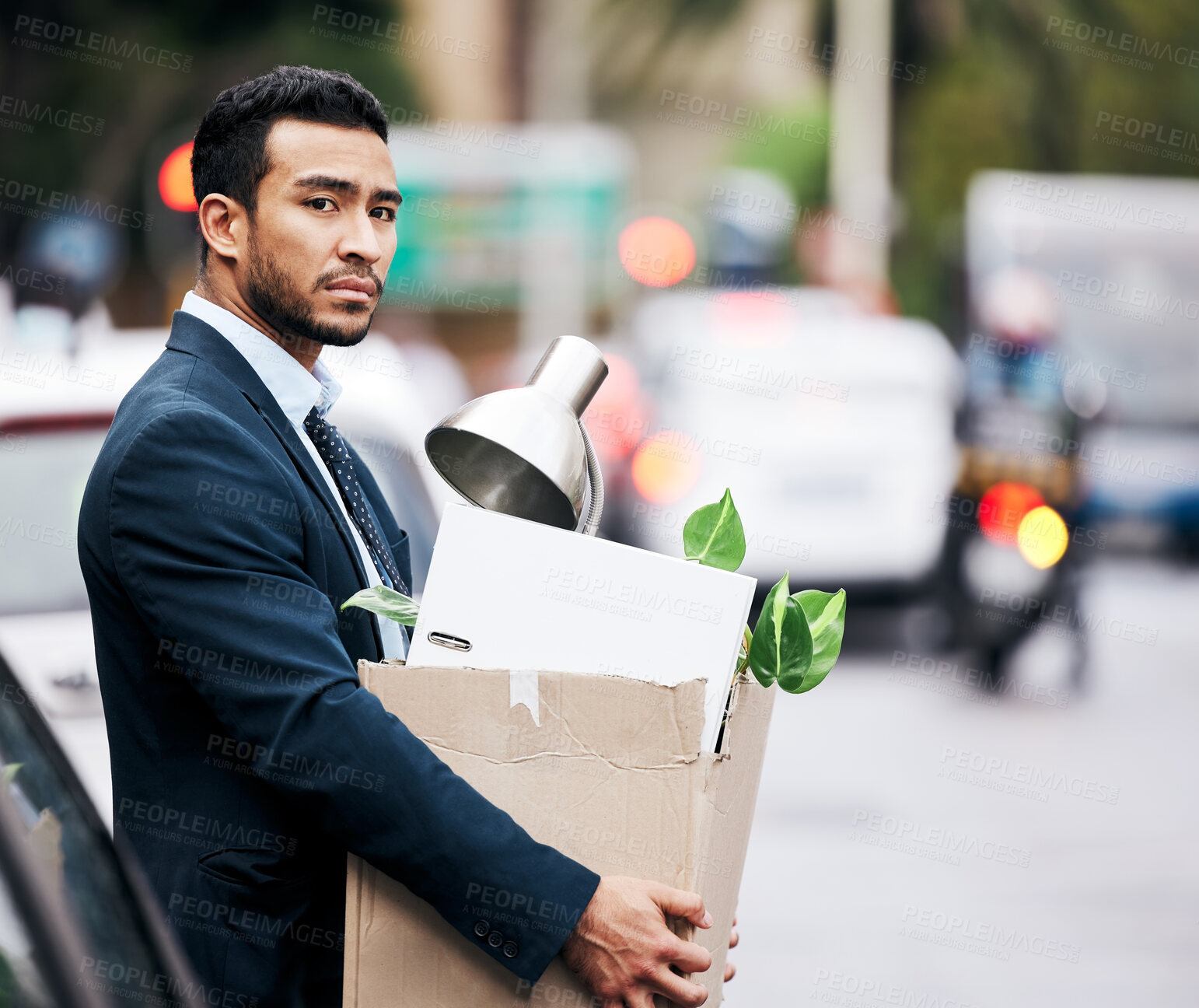 Buy stock photo Depression, economy and a fired business man carrying a box while walking outdoor in the city. Financial crisis, unemployment and jobless with a young male employee looking sad in an urban town