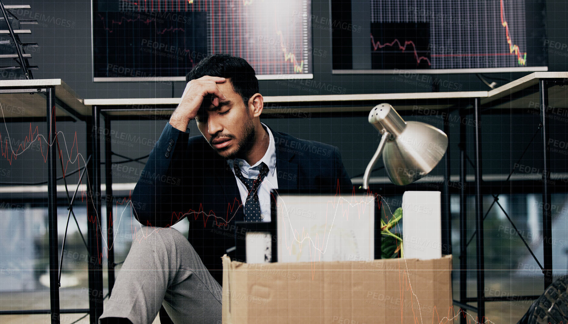 Buy stock photo Shot of a young businessman looking depressed after being retrenched from work in a office