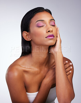 Buy stock photo Relax, makeup and Indian woman in studio, beauty and facial aesthetic with confidence. Female model, vibrant glow or color and cosmetics by white background, eyeshadow and lipstick with hand gesture