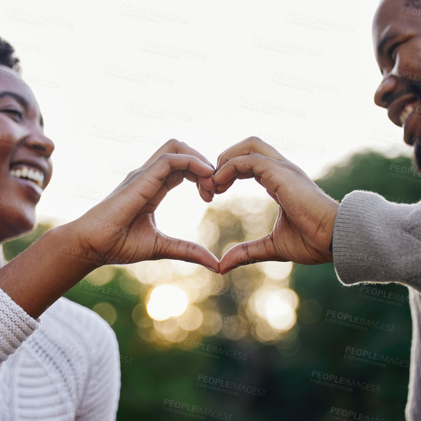 Buy stock photo Black couple, hand heart and smile outdoor with trust for relationship, support and commitment for healthy marriage. Romantic date, African woman and man with love emoji or icon for care in nature