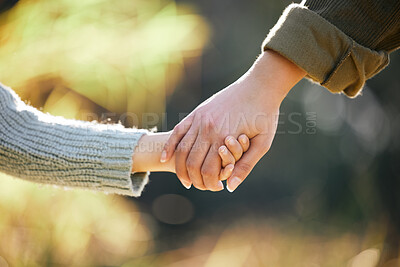 Buy stock photo Holding hands, love or mother and child at park for travel, bonding and support in nature together at sunset. Security, safety and mama with kid in forest with hope, help and guidance, trust and care