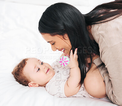 Buy stock photo Mother, hug and baby on a bed with love, care and morning bonding games in their home together. Happy family, child development and woman playing with son in a bedroom with support, safety and trust