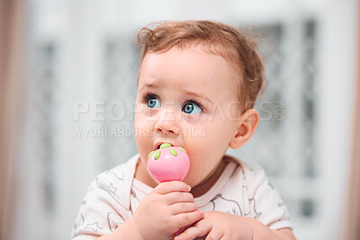 Buy stock photo Bedroom, teething and baby in home for fun playing, mouth toy or learning in living room to relax. Biting, healthy boy or face of curious kid sitting in house alone for child development or growth