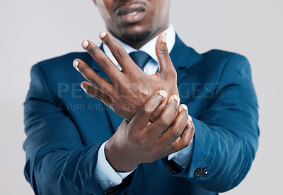 Buy stock photo Hands, pain and African businessman with injury in studio from tension, arthritis and stress. Wrist, muscle and problem or sprain by white background with unhappy, corporate and male person in suit